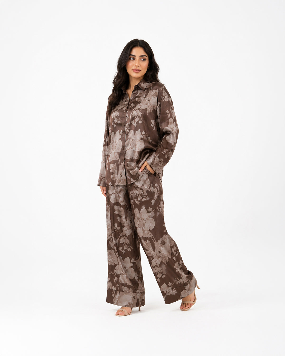 Studio view of the Sahara Bloom bronze silk co-ord set with a relaxed button-front shirt and floral-print trousers.