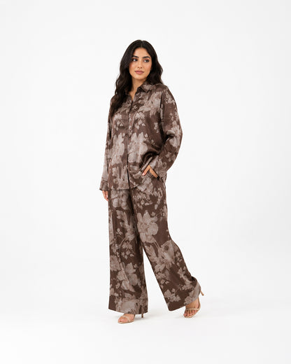 Studio view of the Sahara Bloom bronze silk co-ord set with a relaxed button-front shirt and floral-print trousers.