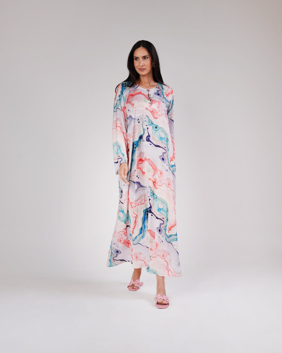 Model wearing the Lagoon Pearl & Coral silk dress in coral, aqua and lavender tones.