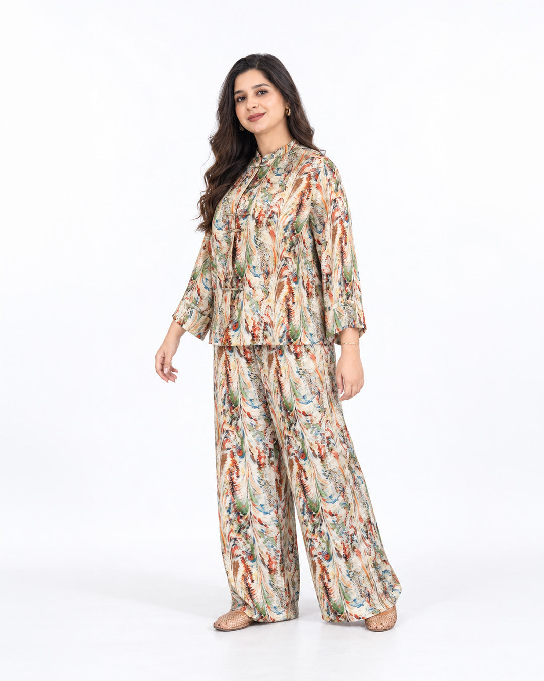 Model wearing the L’Artiste beige multicolour printed co-ord set with a relaxed shirt and matching wide-leg trousers.