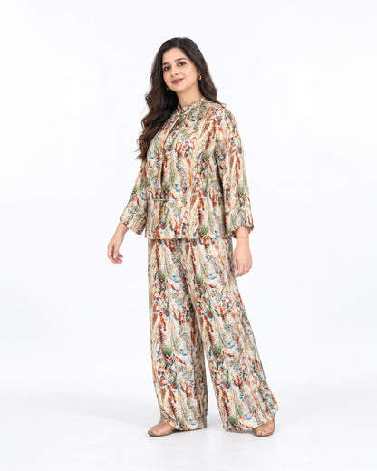 Model wearing the L’Artiste beige multicolour printed co-ord set with a relaxed shirt and matching wide-leg trousers.