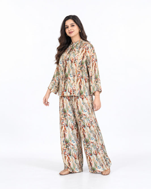 Model wearing the L’Artiste beige multicolour printed co-ord set with a relaxed shirt and matching wide-leg trousers.