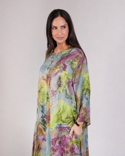 Model wearing Mirelle dark purple and green printed dress with long chiffon sleeves