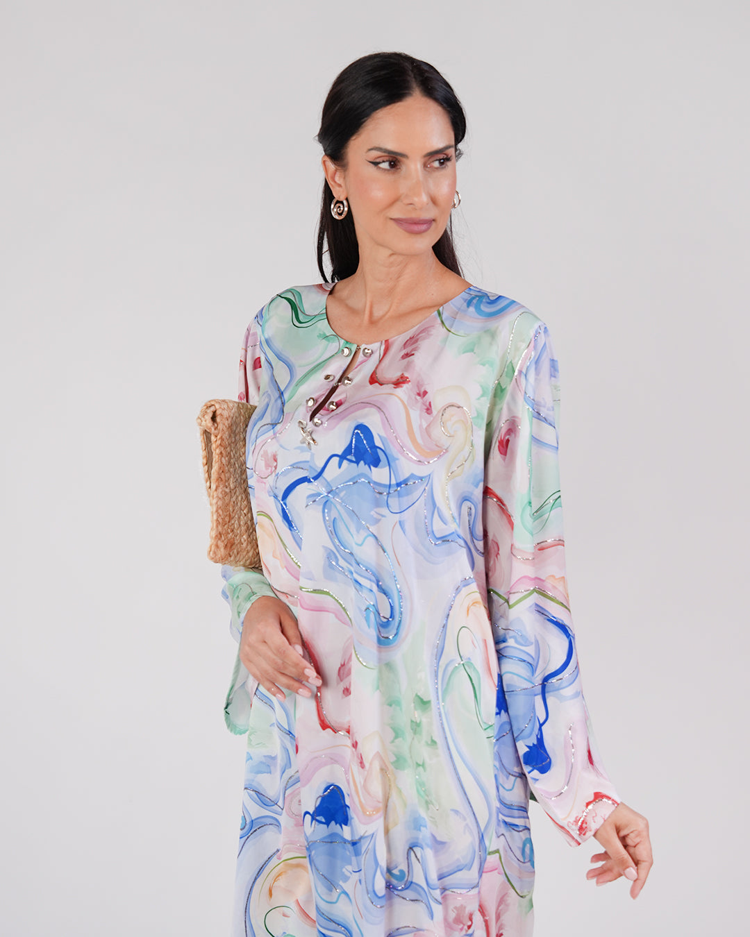 Model wearing the Lagoon Opal silk dress, showing its neckline and flowing sleeves.