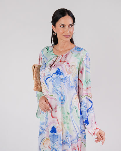 Model wearing the Lagoon Opal silk dress, showing its neckline and flowing sleeves.