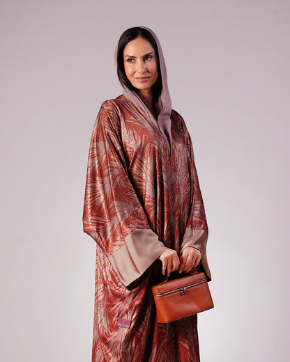 Mid-length front view showing the abaya’s patterned fabric and taupe sleeve cuffs.