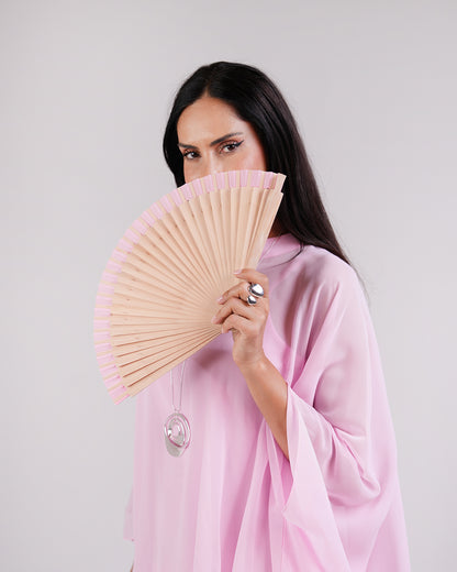 Upper-body view of the Élan pink chiffon dress styled with a fan.