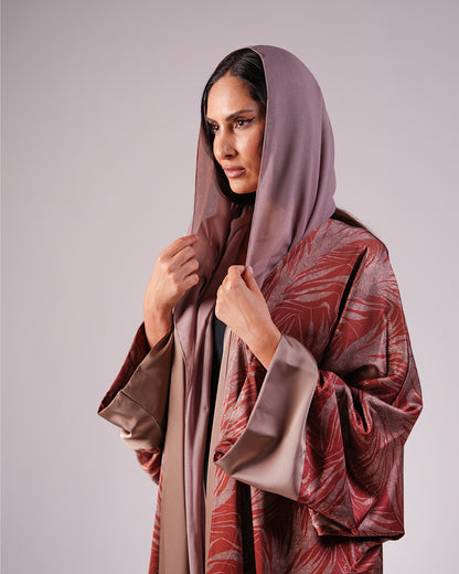 Close-up of the taupe headscarf, sienna pattern and wide sleeve cuffs.