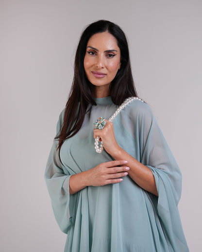 Closer front view of the Élan sage dress’s neckline and layered fabric.