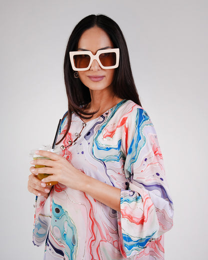 Close-up of the dress’s pearl-toned base and colourful ocean-inspired print.