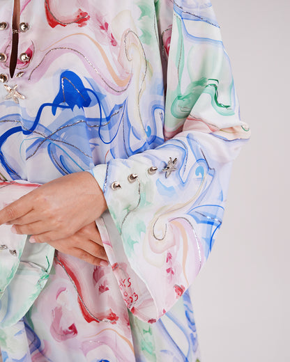 Close-up of the Lagoon Opal dress’s ocean-inspired print and sleeve detail.