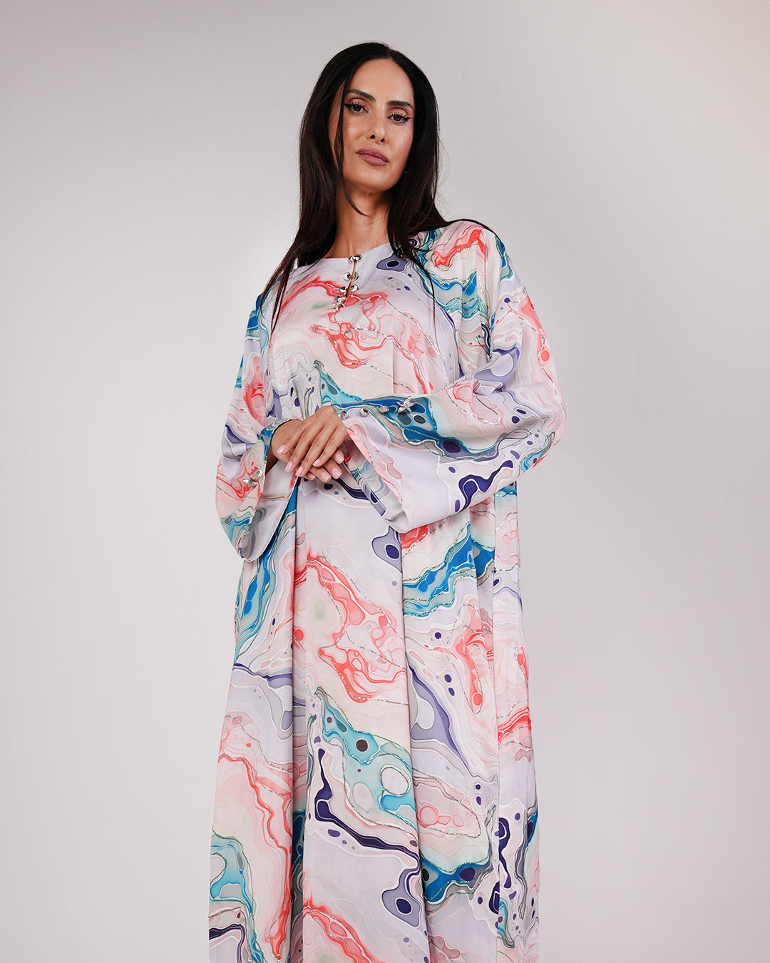 Model styling the Lagoon Pearl & Coral silk dress with sunglasses.