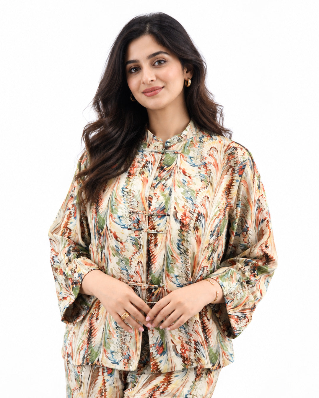 Front view of the L’Artiste printed shirt showing its decorative fastenings, flared sleeves and relaxed fit.
