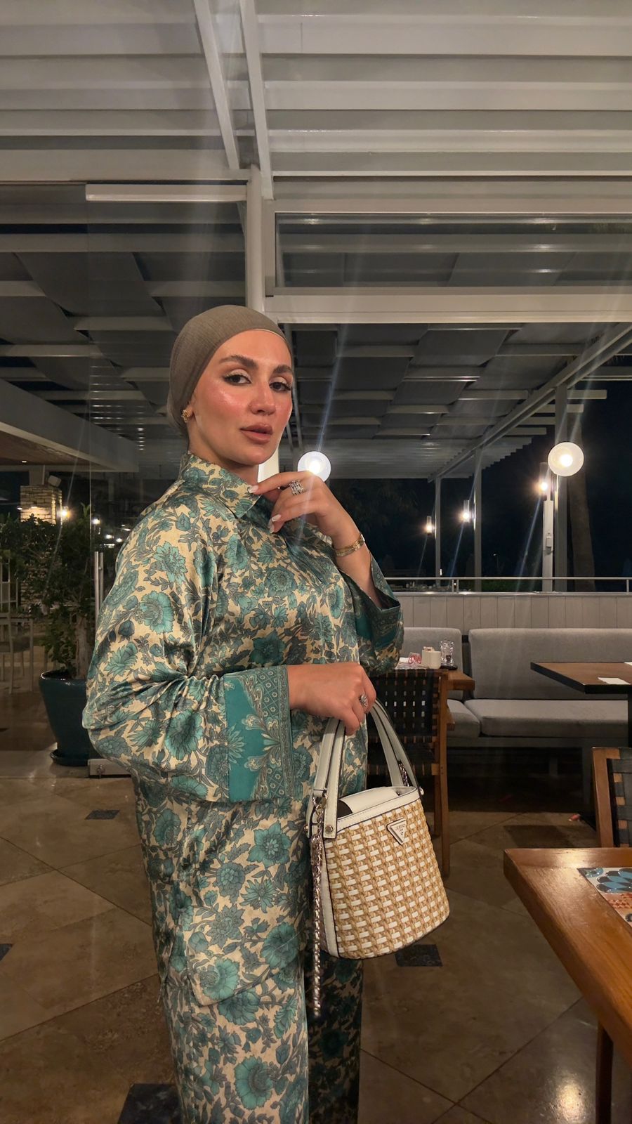 Veluna Atelier client wearing a teal floral modest outfit at an evening restaurant